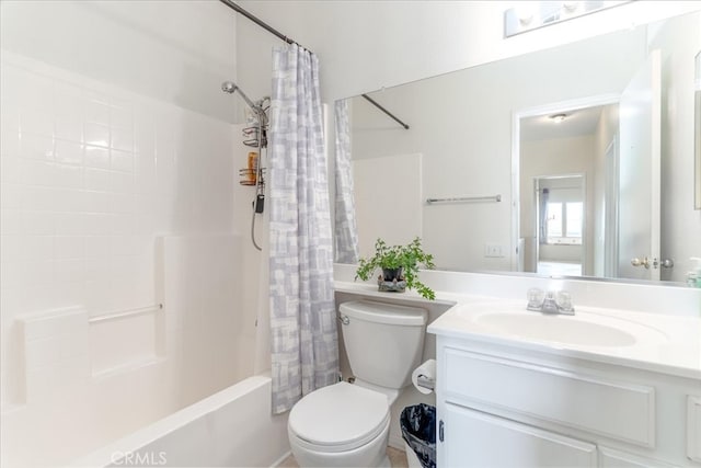 bathroom with vanity, shower / bath combo with shower curtain, and toilet