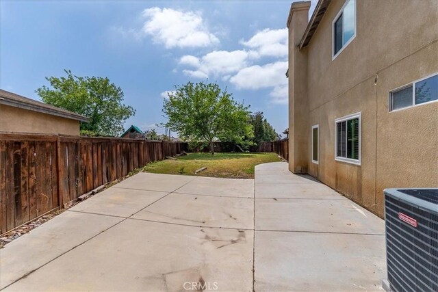 view of patio / terrace with central air condition unit and a fenced backyard