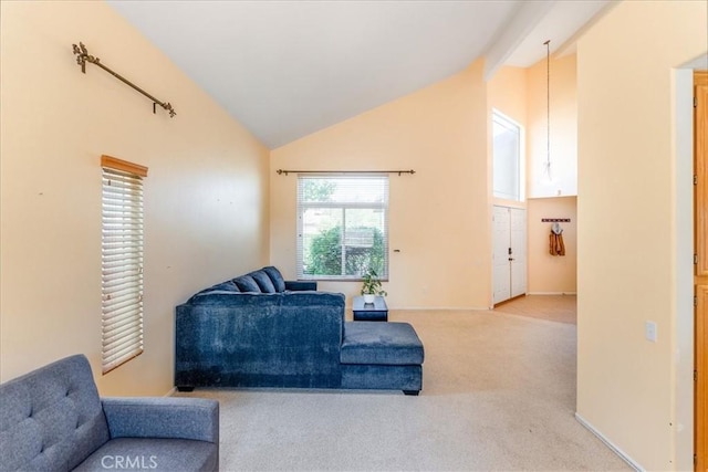 sitting room with high vaulted ceiling and carpet