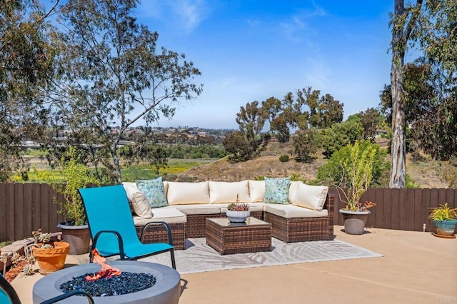 view of patio / terrace with a fenced backyard and an outdoor living space with a fire pit