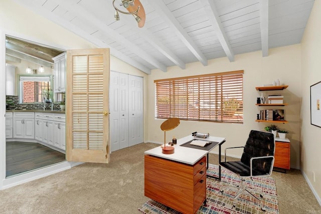 carpeted home office featuring wood ceiling, baseboards, and vaulted ceiling with beams