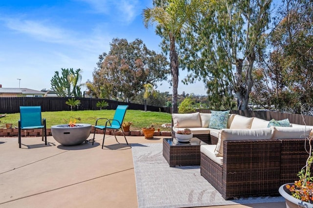 view of patio / terrace featuring a fenced backyard and an outdoor living space with a fire pit