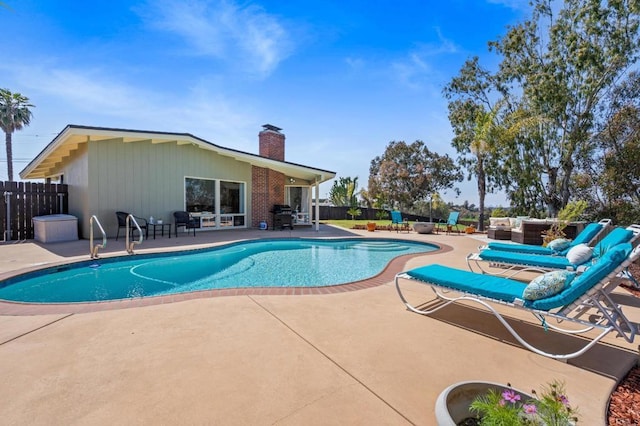view of swimming pool featuring a fenced in pool, fence, a grill, and a patio area