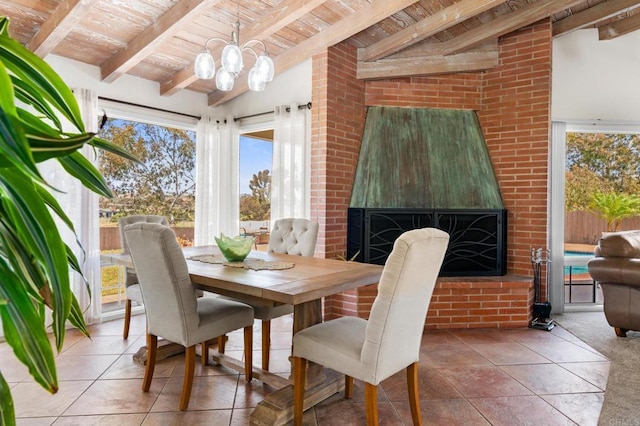 sunroom / solarium featuring plenty of natural light, beamed ceiling, and a notable chandelier
