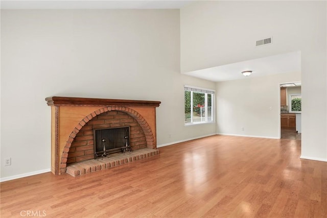 766 Harper St, Simi Valley, CA 93065 - unfurnished living room featuring a high ceiling, wood finished floors, a fireplace, and baseboards