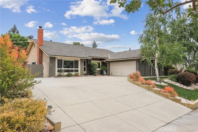 single story home featuring a garage, roof with shingles, stucco siding, a chimney, and concrete driveway