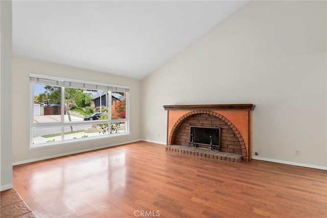766 Harper St, Simi Valley, CA 93065 - unfurnished living room featuring high vaulted ceiling, wood finished floors, baseboards, and a brick fireplace