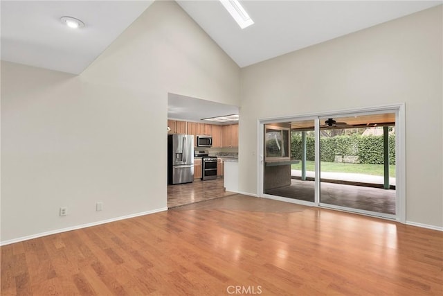 766 Harper St, Simi Valley, CA 93065 - unfurnished living room with high vaulted ceiling, baseboards, light wood-style flooring, and a ceiling fan