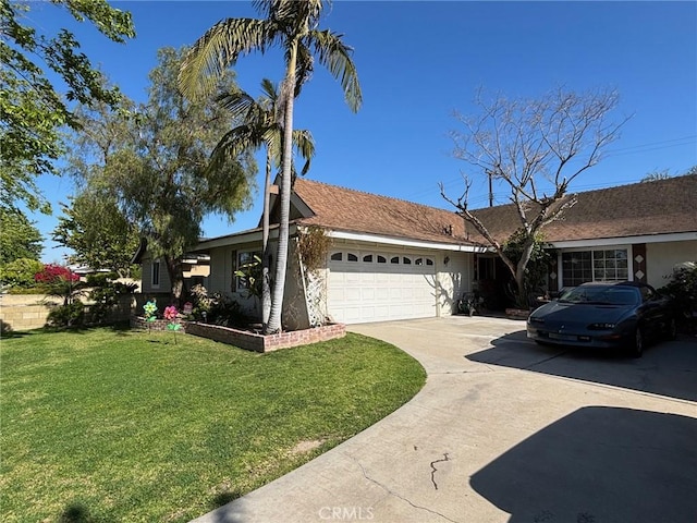 ranch-style house featuring an attached garage, concrete driveway, and a front yard