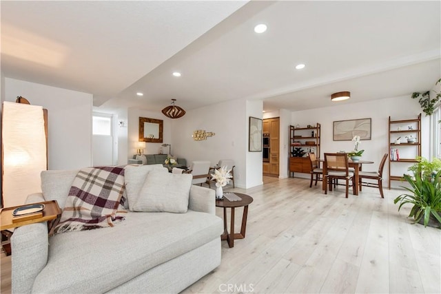 living room with light wood-style flooring and recessed lighting