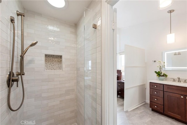 bathroom featuring a stall shower, vanity, and tile patterned flooring