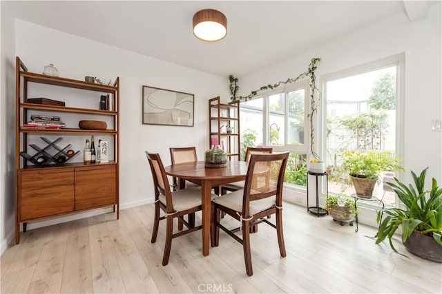dining room with light wood-style flooring and baseboards