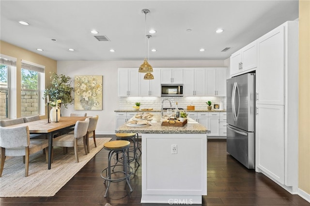 15 Clover, Lake Forest, CA 92630 - kitchen featuring stainless steel appliances, dark wood finished floors, an island with sink, white cabinetry, and recessed lighting