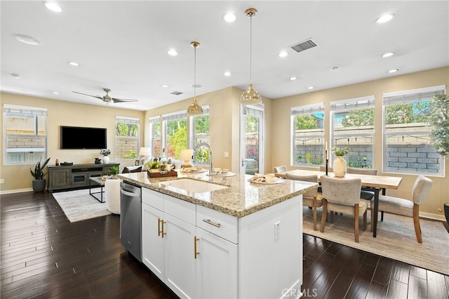 15 Clover, Lake Forest, CA 92630 - kitchen with a sink, stainless steel dishwasher, baseboards, light stone countertops, and white cabinets