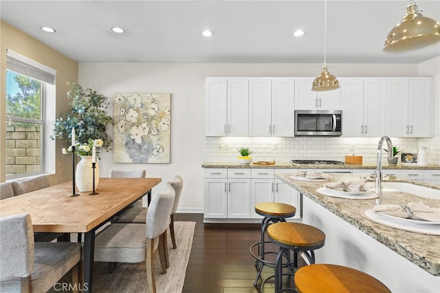 15 Clover, Lake Forest, CA 92630 - kitchen featuring appliances with stainless steel finishes, a sink, white cabinetry, dark wood-style flooring, and recessed lighting