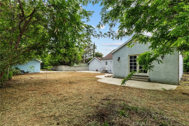9438 Burnet Ave, North Hills, CA 91343 - view of yard featuring an outdoor structure, a patio area, and entry steps