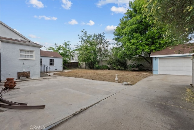 9438 Burnet Ave, North Hills, CA 91343 - view of patio / terrace featuring fence, concrete driveway, and a garage