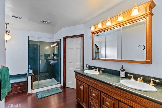 9438 Burnet Ave, North Hills, CA 91343 - bathroom with double vanity, a sink, wood finished floors, and a shower stall