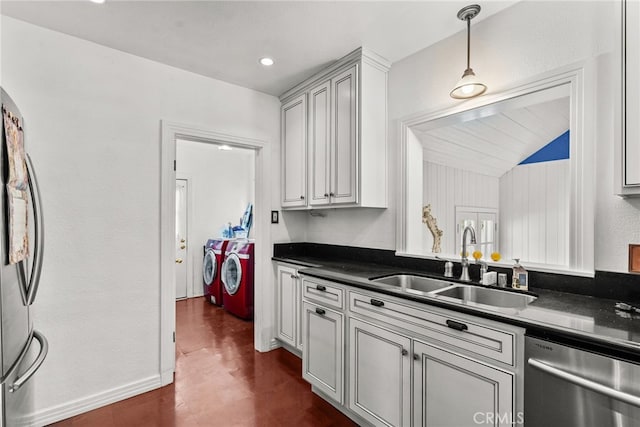 9438 Burnet Ave, North Hills, CA 91343 - kitchen featuring pendant lighting, dark countertops, independent washer and dryer, a sink, and appliances with stainless steel finishes
