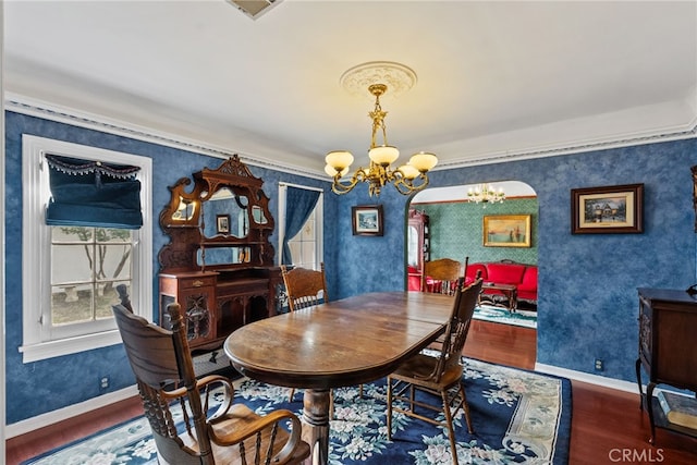 9438 Burnet Ave, North Hills, CA 91343 - dining space with wallpapered walls, a chandelier, ornamental molding, and wood finished floors