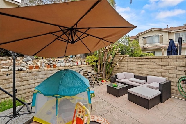 view of patio featuring fence and an outdoor hangout area