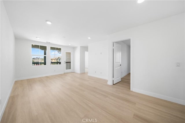 spare room with light wood-style floors, baseboards, and recessed lighting