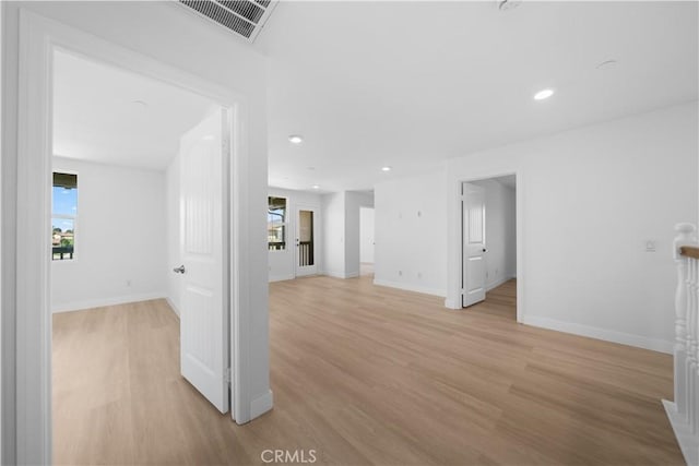 unfurnished room featuring light wood-style floors, baseboards, and recessed lighting