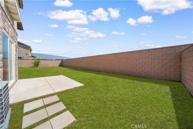 view of yard featuring a patio area, central AC unit, and a water view