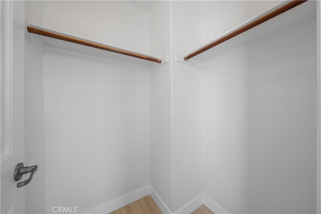 walk in closet featuring light wood-style flooring
