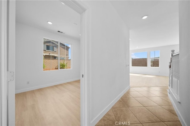 hallway with baseboards and recessed lighting