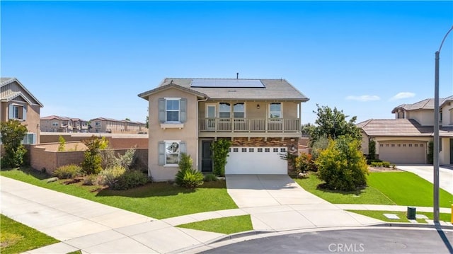 view of front of house with stucco siding, solar panels, concrete driveway, a garage, and a residential view