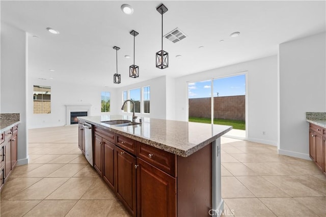 kitchen with a sink, dishwasher, open floor plan, light tile patterned flooring, and recessed lighting