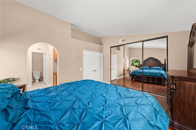 11820 Mount Wilson Ct, Rancho Cucamonga, CA 91737 - bedroom with arched walkways, ensuite bath, light tile patterned flooring, and visible vents