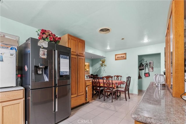 12036 Jouett St, Sylmar, CA 91342 - kitchen with fridge with ice dispenser, light tile patterned flooring, and light countertops