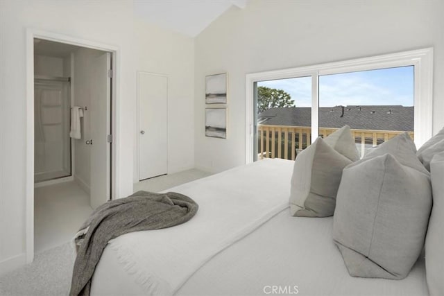 carpeted bedroom featuring baseboards, lofted ceiling, and access to exterior