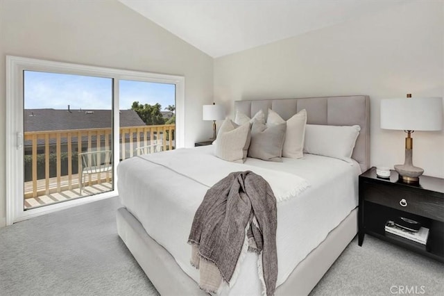 carpeted bedroom featuring vaulted ceiling and access to exterior