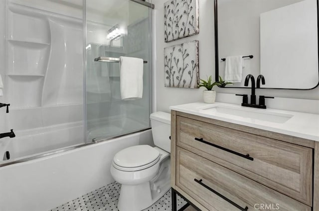 full bathroom featuring vanity, bath / shower combo with glass door, and toilet