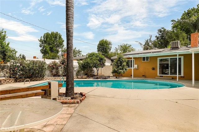 view of swimming pool with a fenced in pool, central AC unit, a patio area, and a fenced backyard