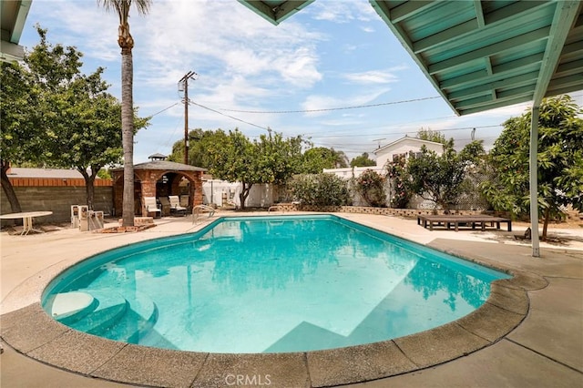 view of swimming pool featuring a gazebo, a fenced backyard, a fenced in pool, and a patio