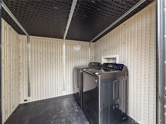 laundry area with laundry area, hardwood / wood-style flooring, and washer and dryer