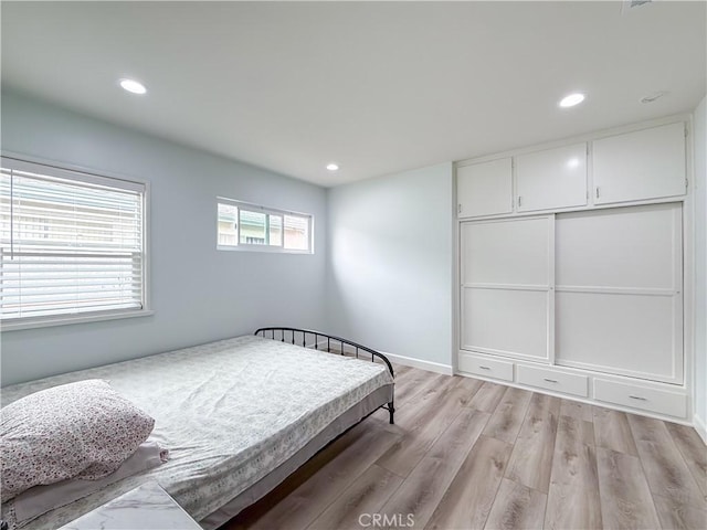 bedroom featuring recessed lighting and light wood-style flooring