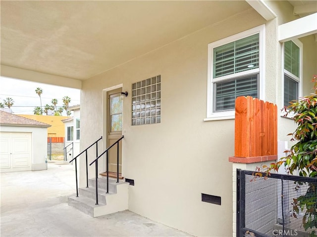 doorway to property featuring stucco siding