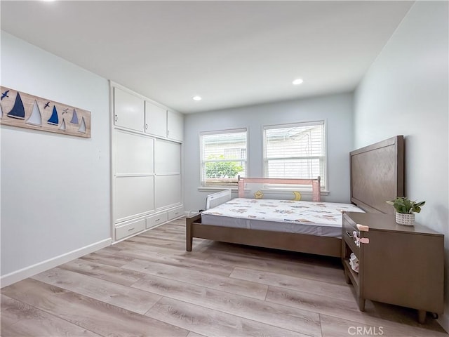 bedroom with light wood-style floors, baseboards, and recessed lighting