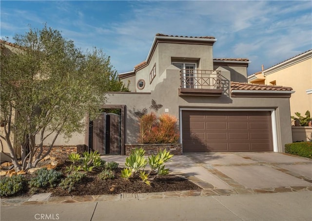 mediterranean / spanish-style house featuring a balcony, concrete driveway, stucco siding, a garage, and a tile roof