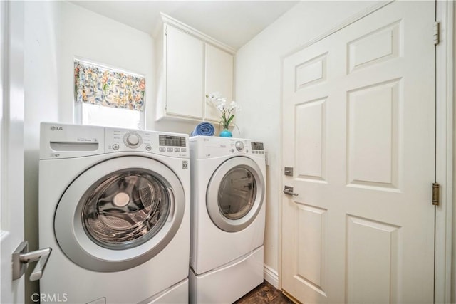 laundry room featuring washing machine and dryer and cabinet space