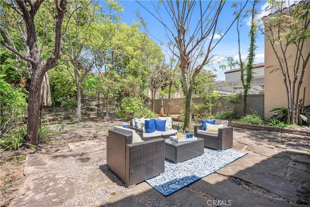 view of patio with outdoor lounge area and fence