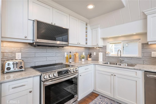 27550 N Bay Rd, Lake Arrowhead, CA 92352 - kitchen with stainless steel appliances, white cabinetry, backsplash, recessed lighting, and light stone countertops