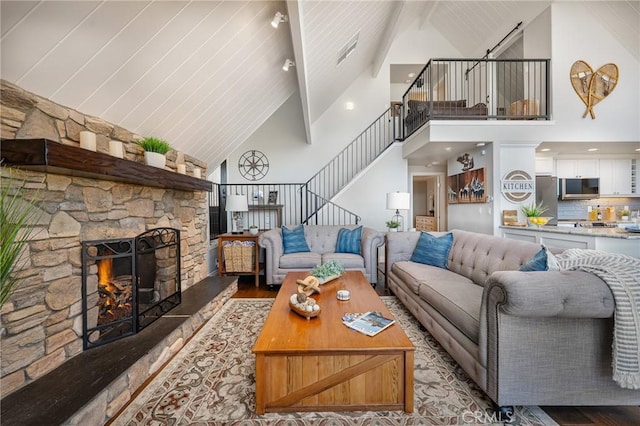 27550 N Bay Rd, Lake Arrowhead, CA 92352 - living area featuring high vaulted ceiling, stairway, wood finished floors, and a fireplace