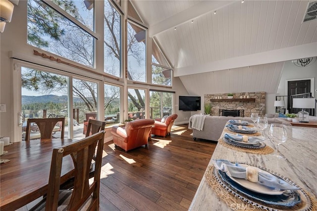 27550 N Bay Rd, Lake Arrowhead, CA 92352 - dining room featuring high vaulted ceiling, dark wood-type flooring, a fireplace, beamed ceiling, and a mountain view