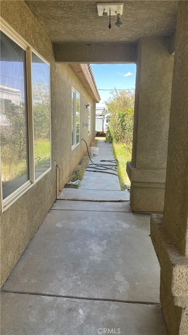 view of home's exterior with stucco siding and a patio area
